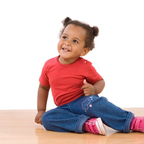 Adorable african baby sit over wooden floor